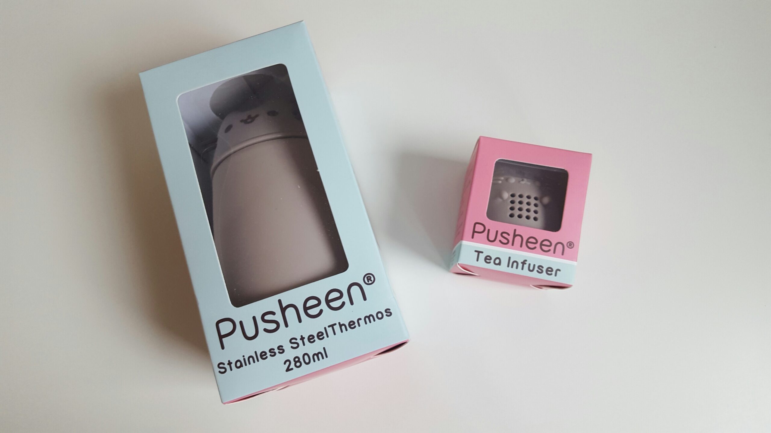 The Pusheen stainless steel thermos and tea infuser in their packaging