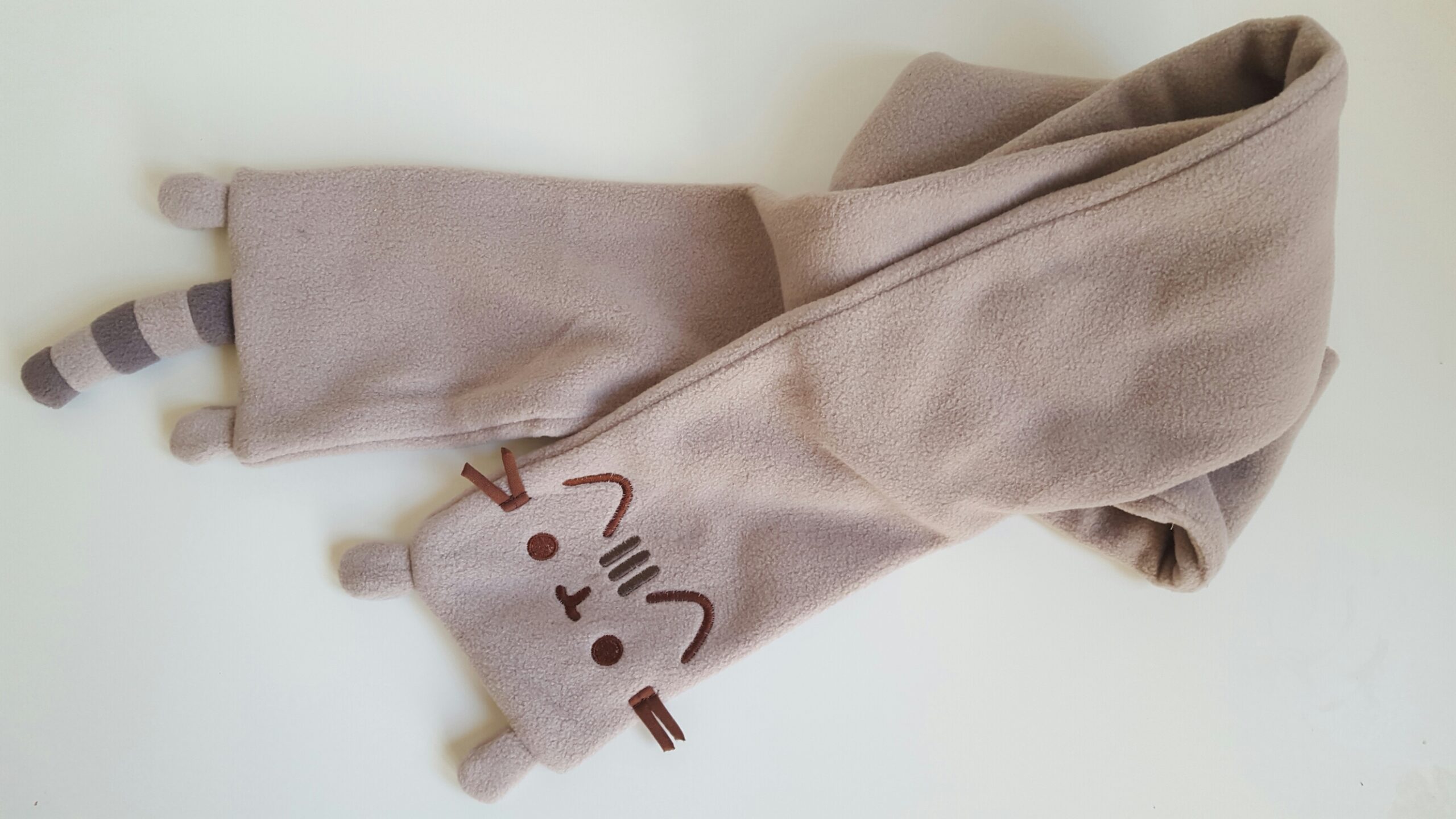 The Pusheen scarf unfolded to show the face and tail