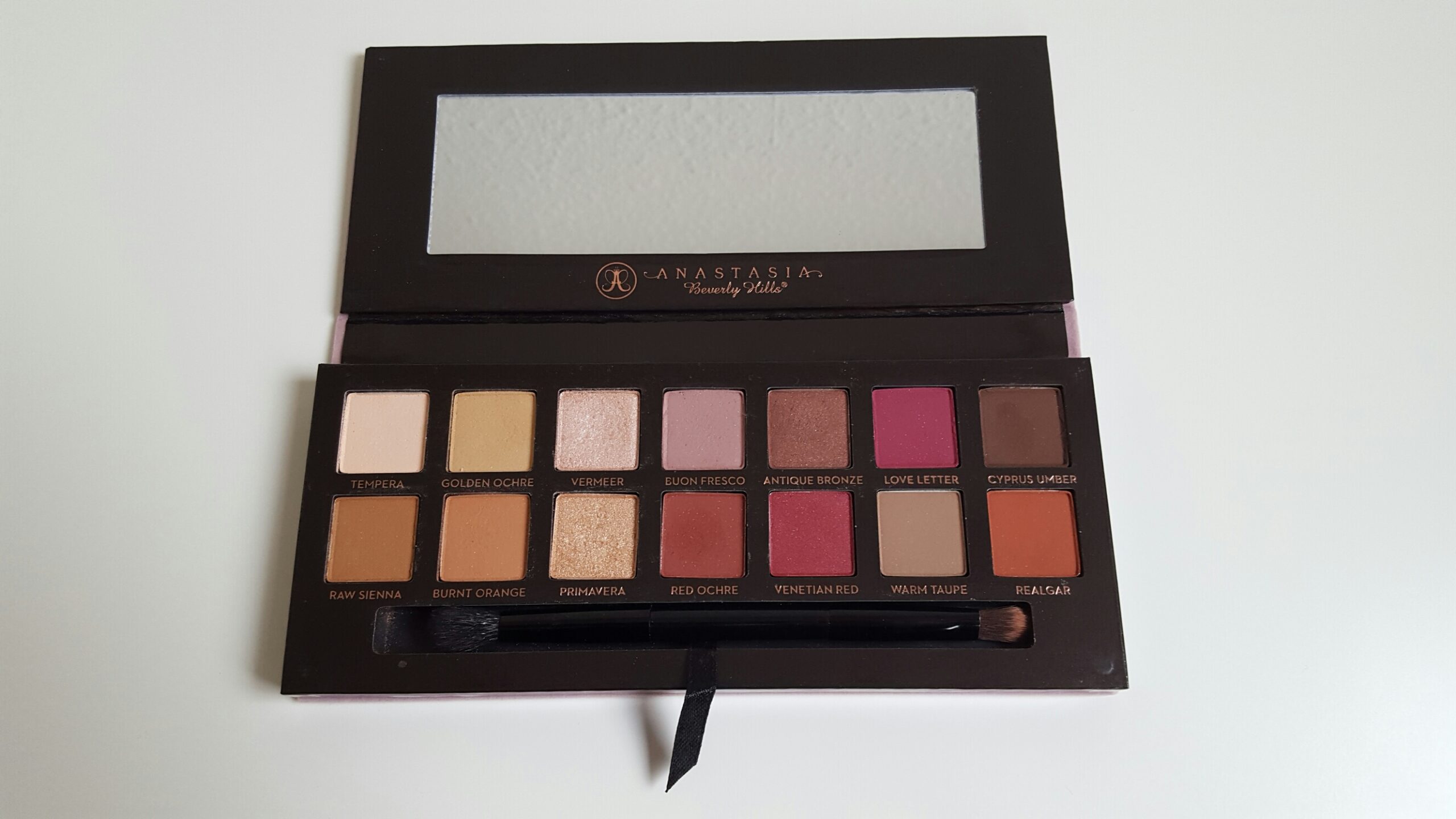The Anastasia Beverly Hills Modern Renaissance Palette opened to show the 14 shades, the mirror, and the brush