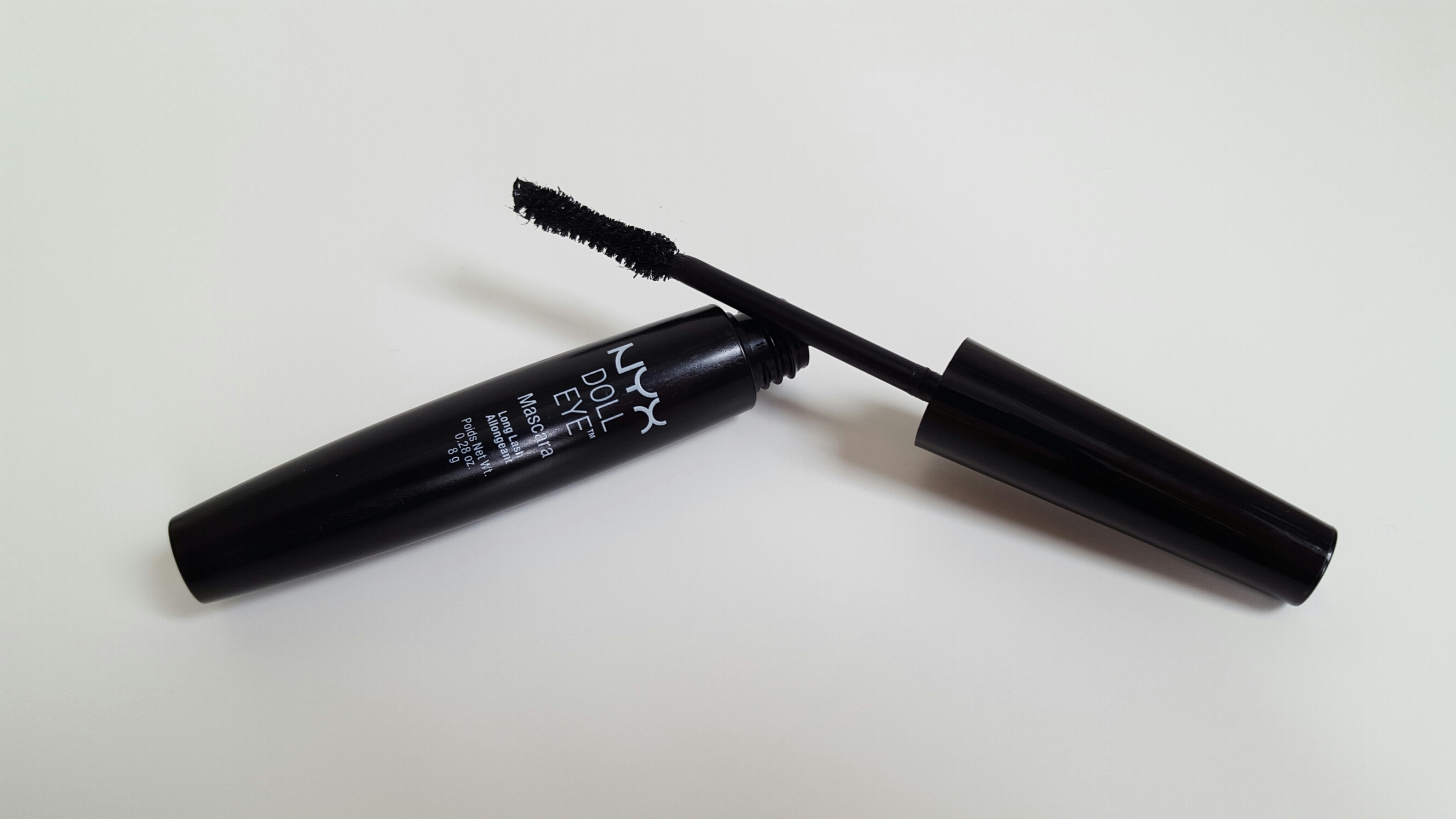The full size of the NYX Doll Eye Mascara which is a black tube with white lettering on the side