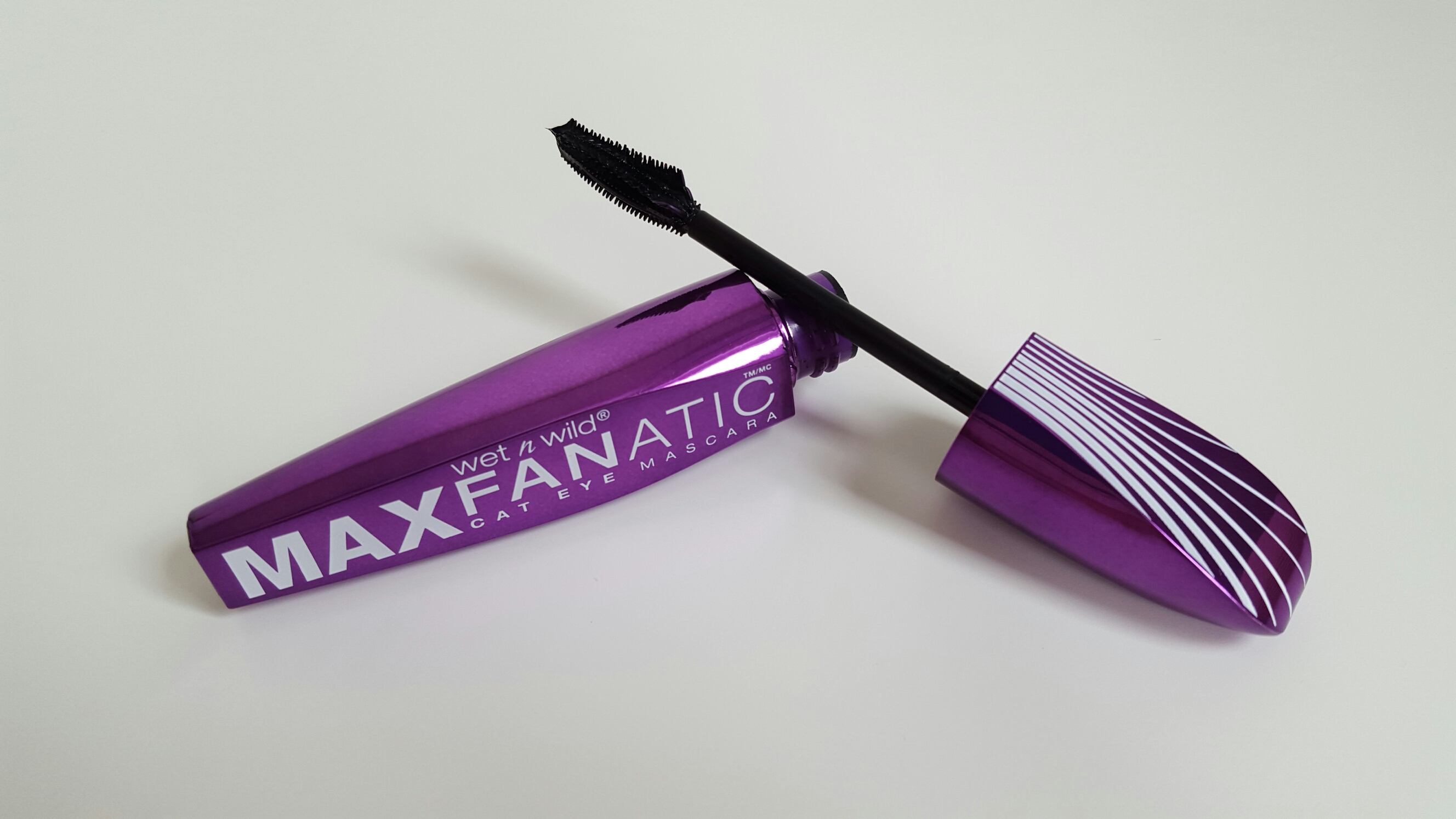 The full size of the Wet n Wild Maxfanatic Mascara which is a metallic purple tube with white stripes on the top