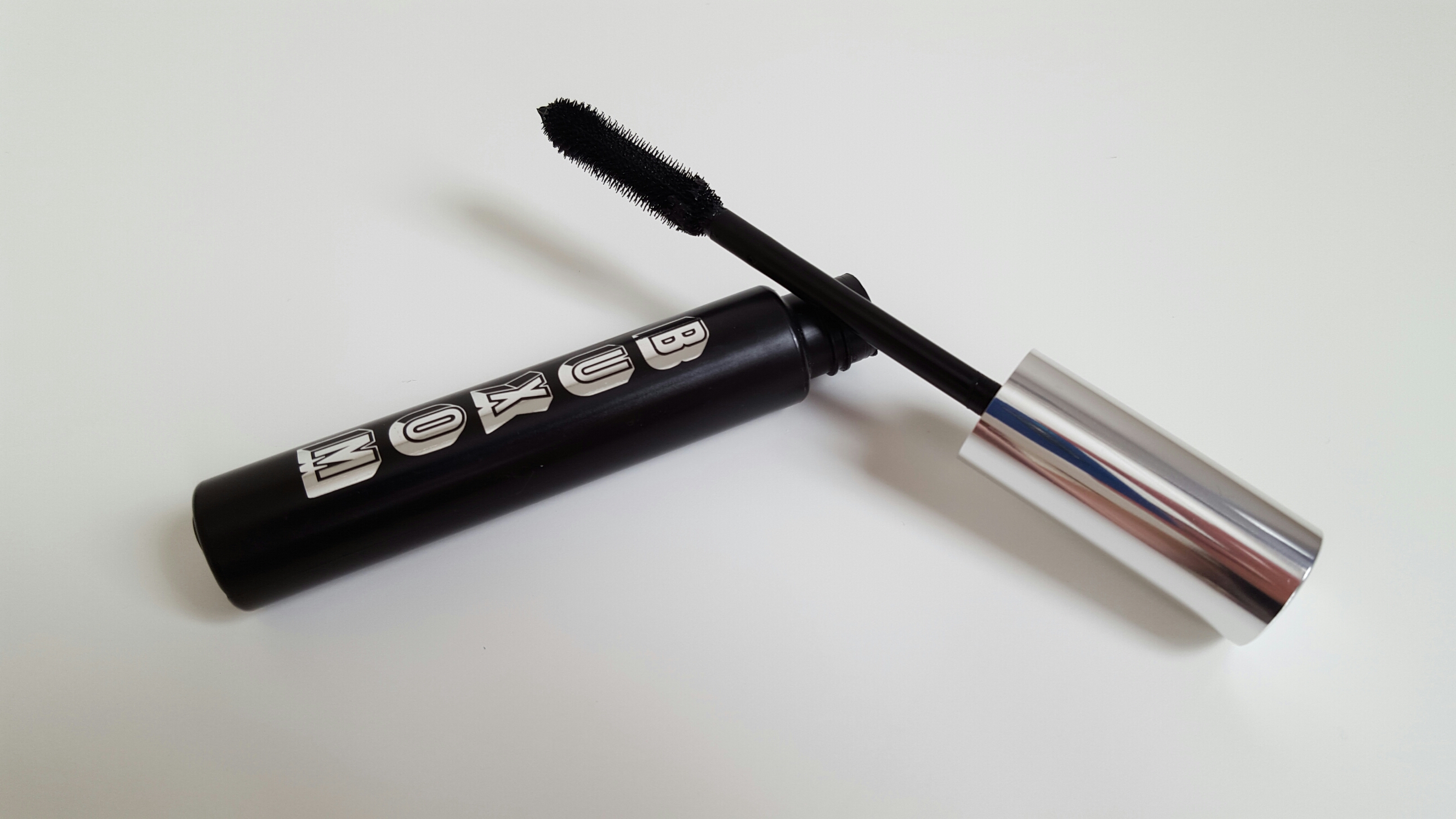 The full size of the Buxom Lash Mascara which is black tube with a silver top