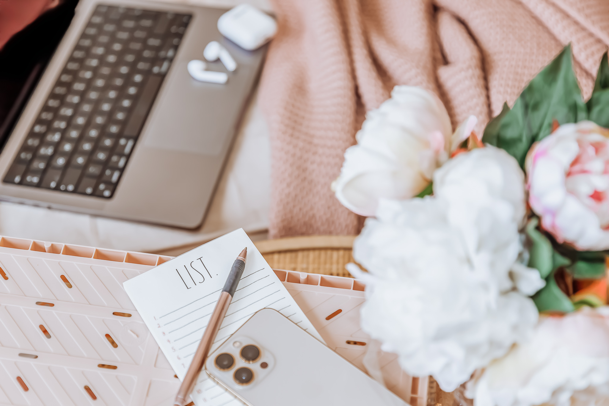 A laptop next to a to-do list and an iphone