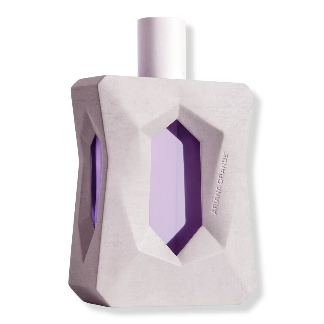 The God Is A Woman perfume which is a white rectangular shape with purple hexagon cutouts.