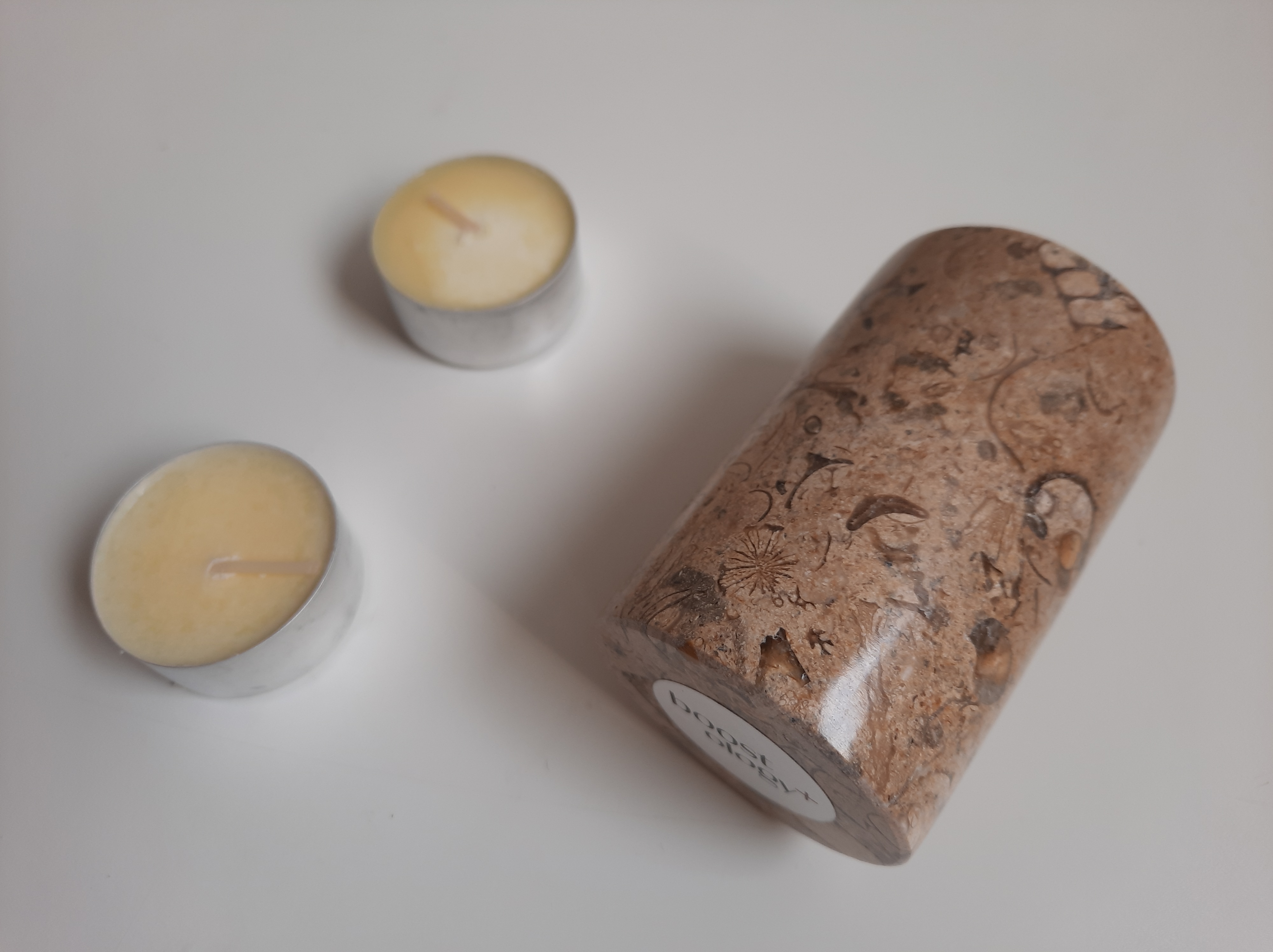 The side of the Boostology fossil stone candle holder 