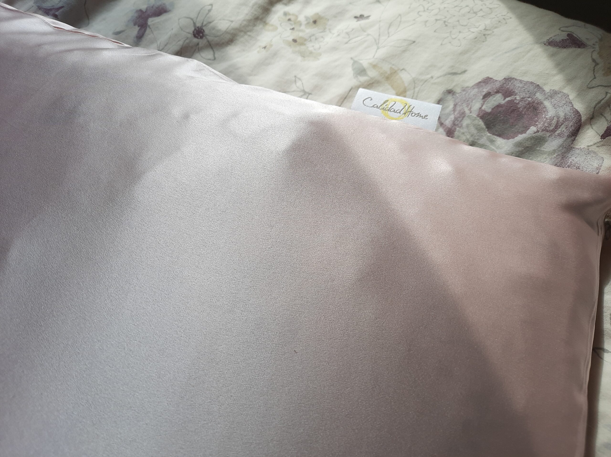 The Calidad Home silk pillowcase on a pillow to show the true size