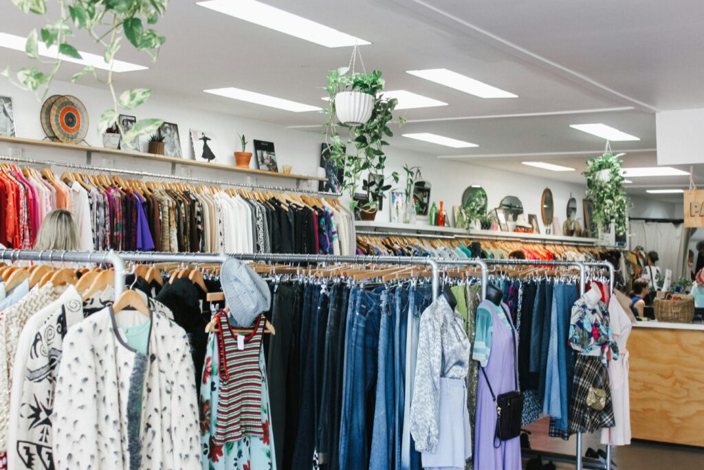 A thrift store with racks of clothing for sale.