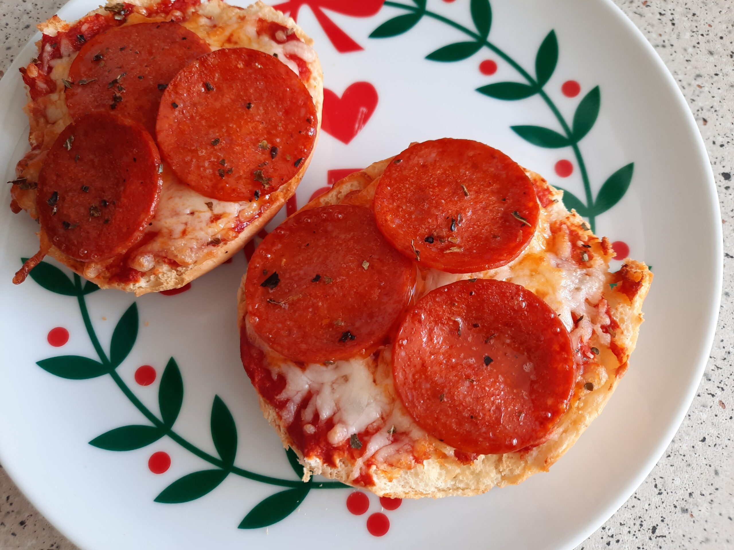 Pizza buns I made in the air fryer that are topped with cheese and pepperoni slices