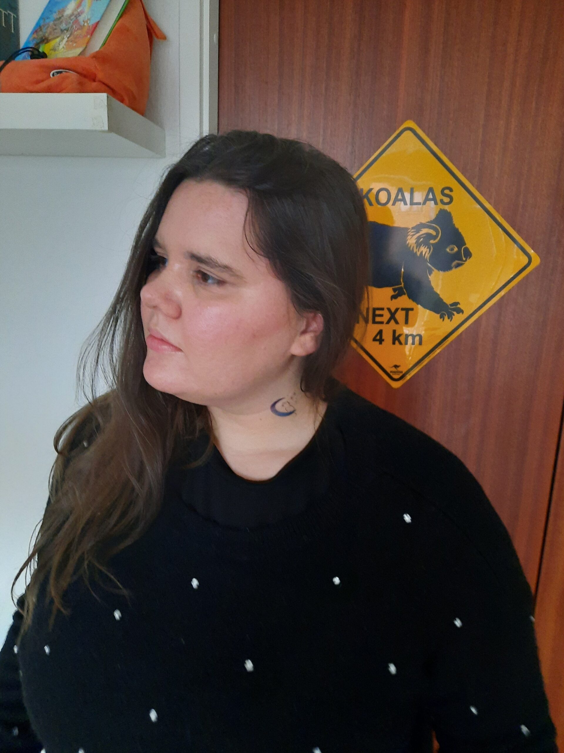 A sweater look where I added the romantic cat tattoo to my neck while wearing a black sweater with shiny beads