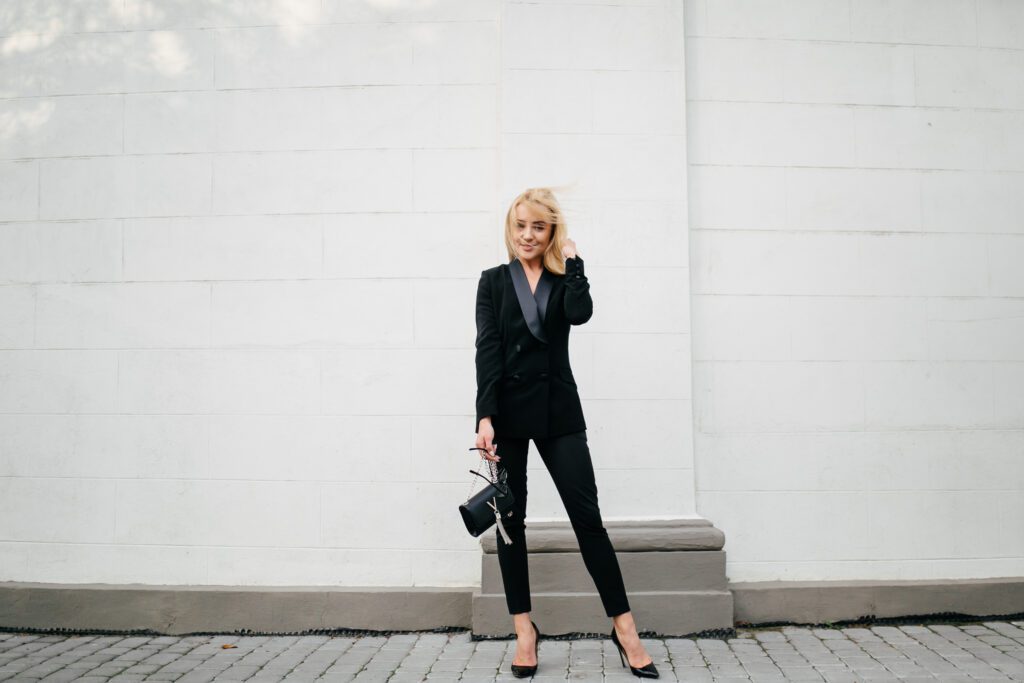 a stylish young lady in a grey suit clothes