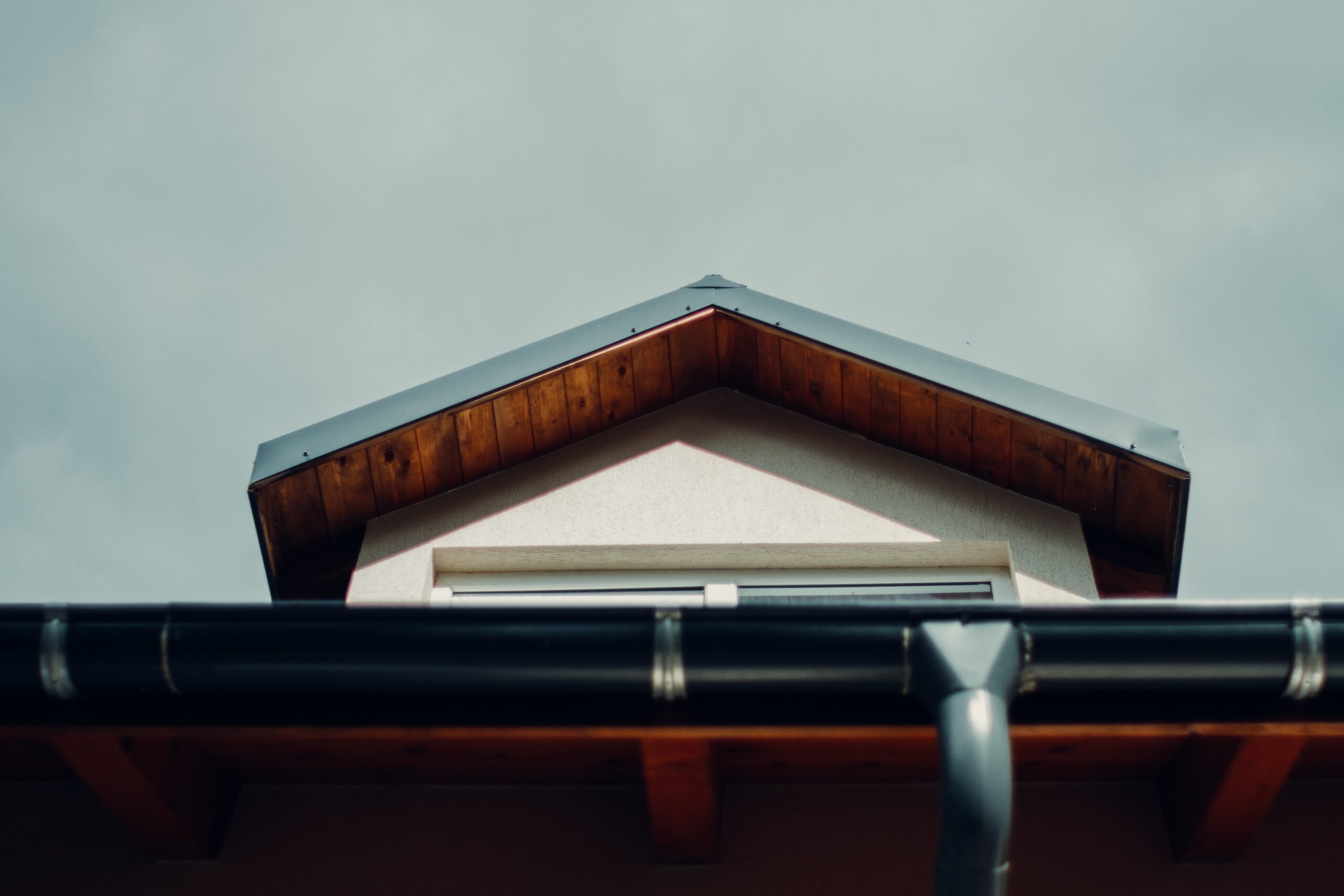 A home exterior of a brown wooden roof with guttering