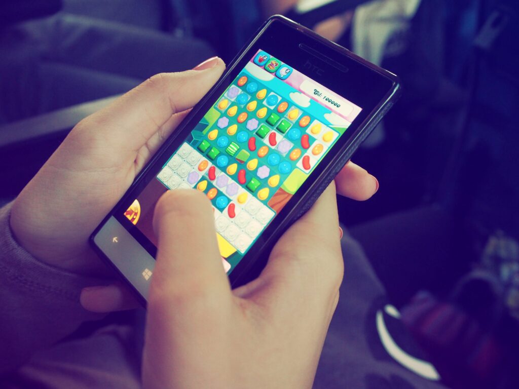 A person playing the game Candy Crush on their phone