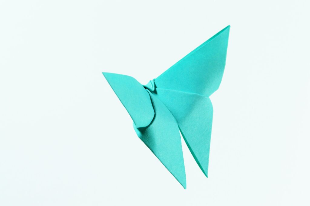 A teal origami paper butterfly