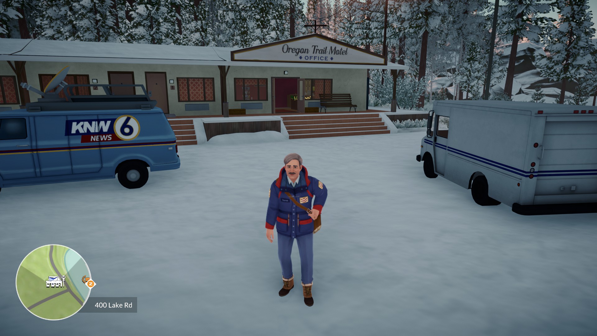 A screenshot from Lake - Season's Greetings where Thomas is delivering mail to the motel. The parking lot and trees are covering in snow.