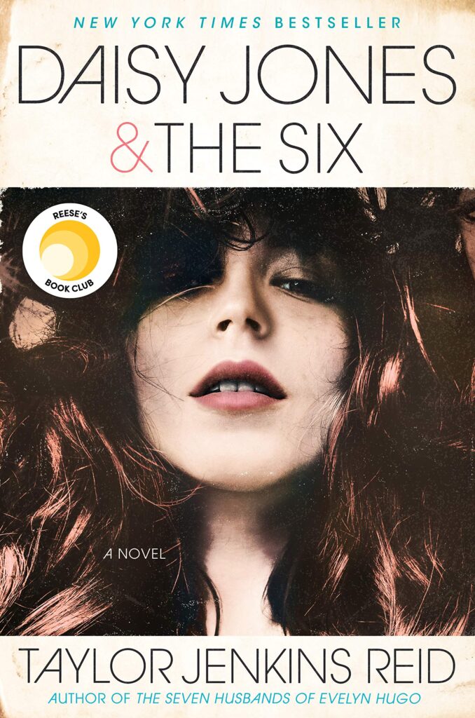 The cover of Daisy Jones and The Six by Taylor Jenkins Reid which shows a portrait of a woman with long wavy brown hair that is partly covering her eyes