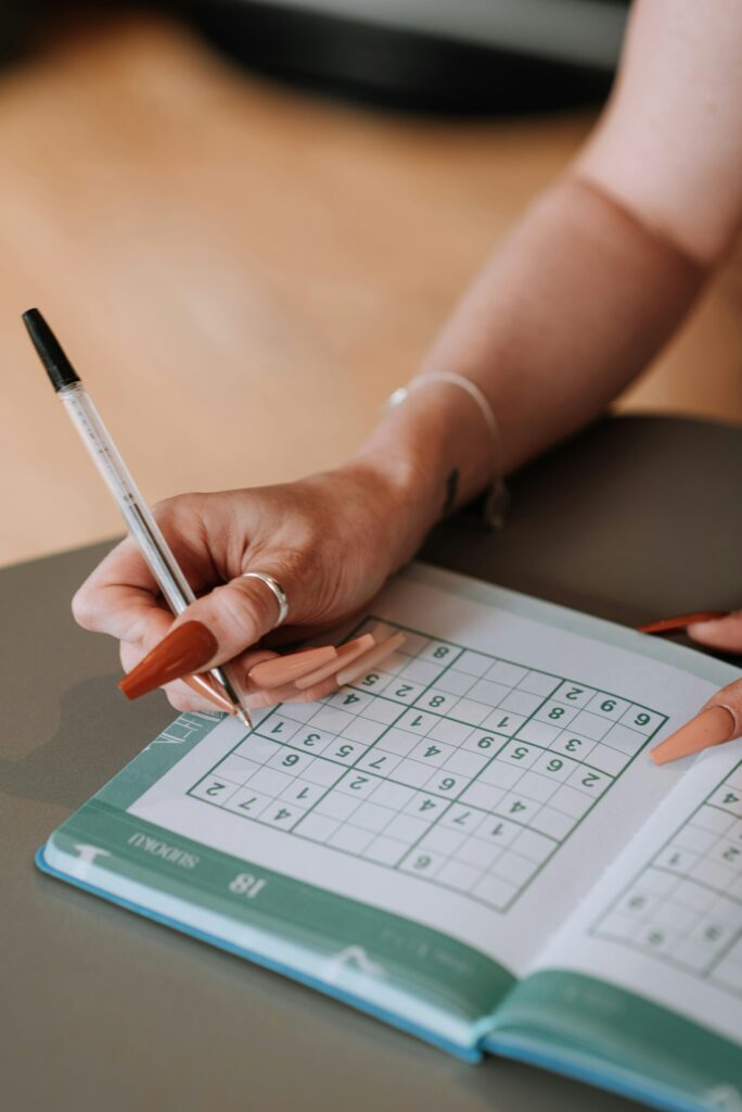 A person solving a suduko puzzle