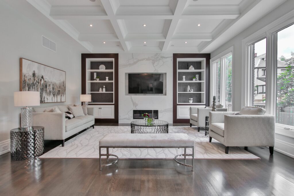 A room with high ceilings that uses a bench to divide the space