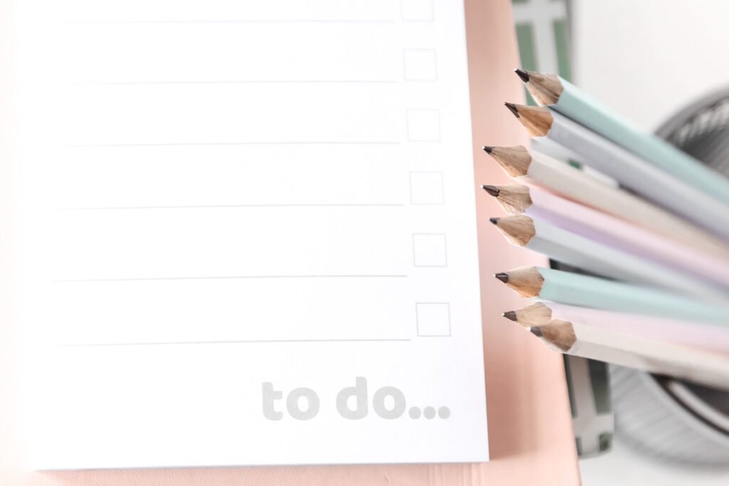 A to do list next to a stack of sharpened pencils