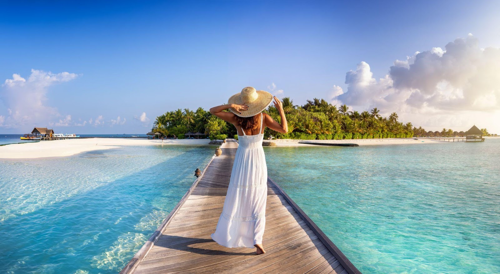 A woman standing on a boardwalk in the Maldives
