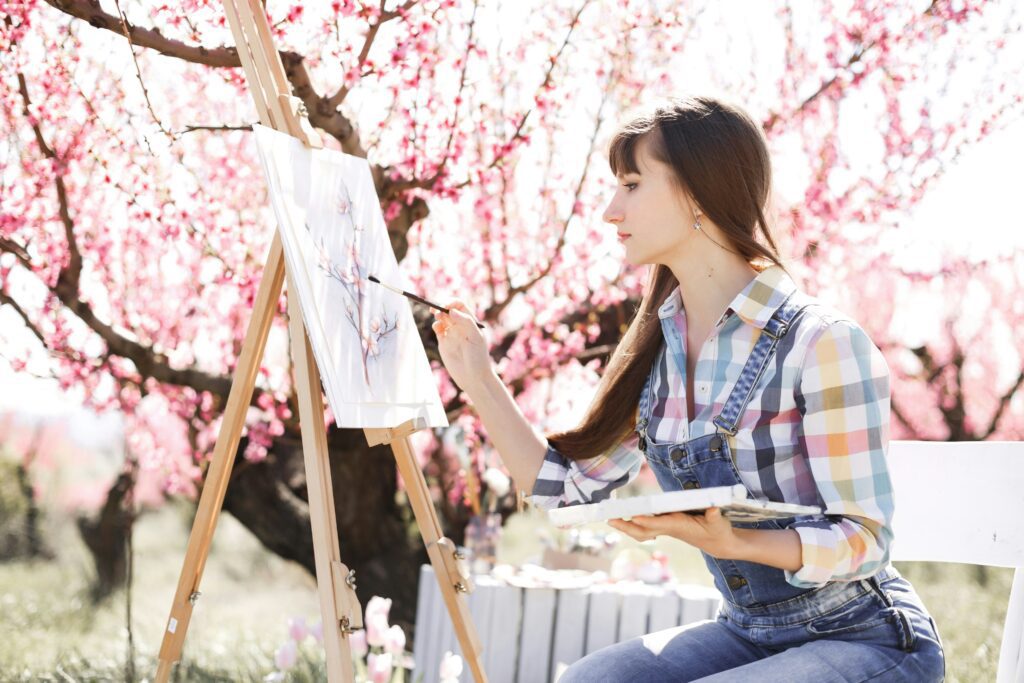 An artist paintng a cherry tree