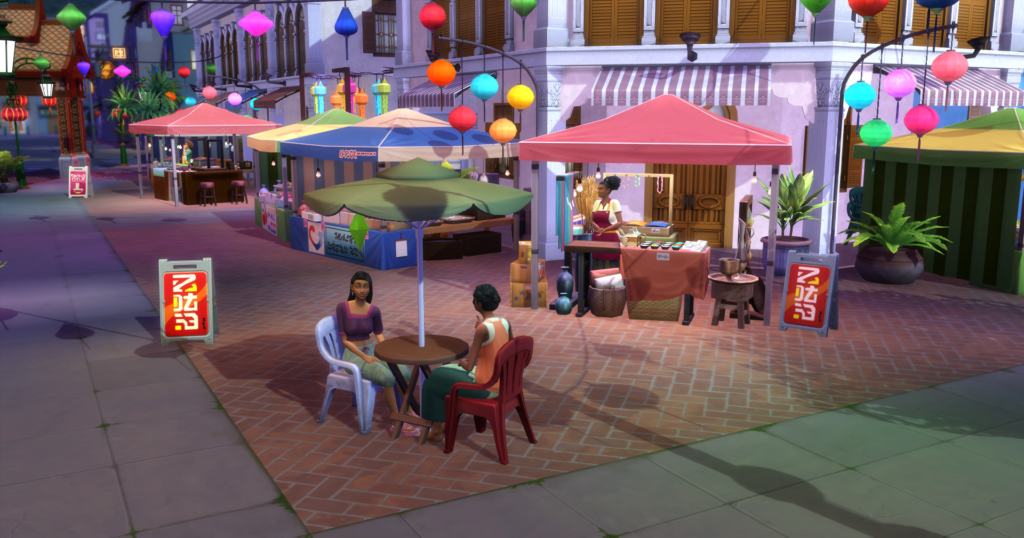 The night market where two sims are sitting at a table and talking in front of a stand
