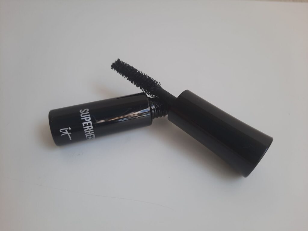 The sample size of the It Cosmetics Superhero Mascara which is a black tube with silver lettering