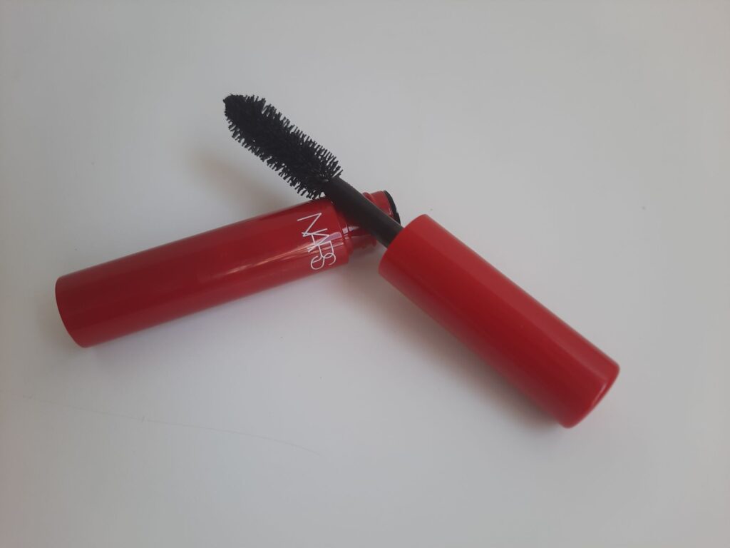 The travel size of the Nars Climax Mascara which is a red tube with white lettering
