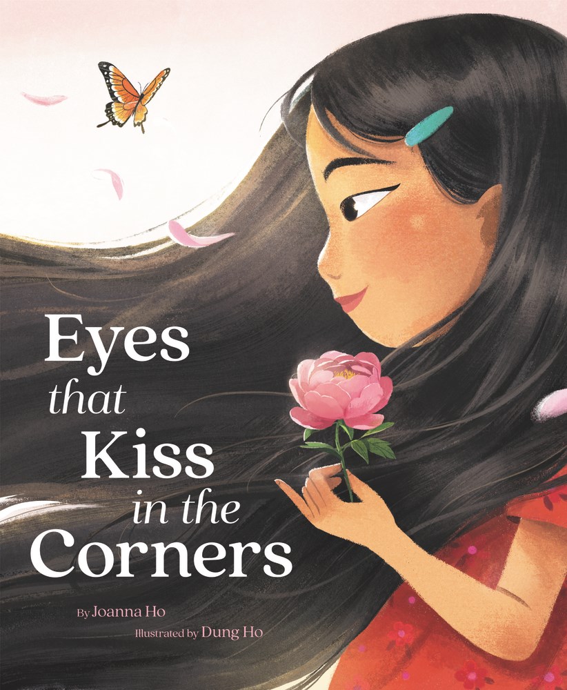 The cover of Eyes That Kiss in the Corners by Joanna Ho which shows an illustration of a side potrait of a Asain girl. The girl is holding a pink flower 