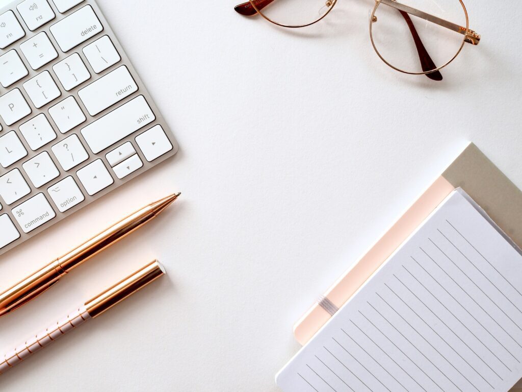 A notebook with a keyboard and pens