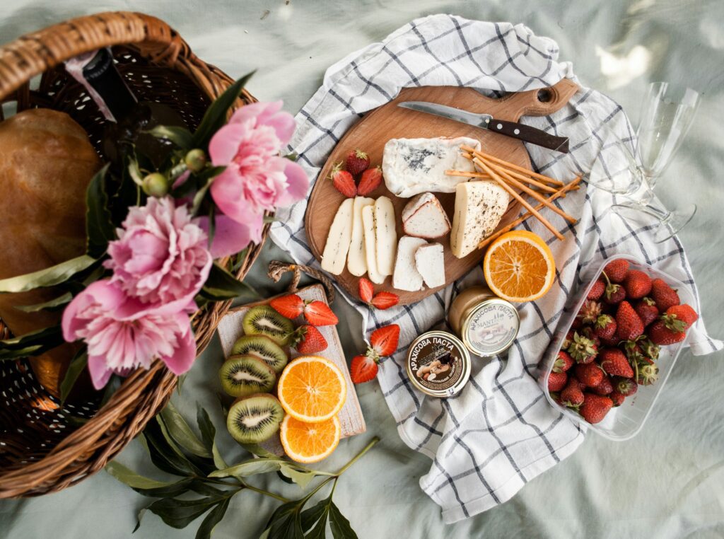 A picnic laid out with fresh fruit and cheeses