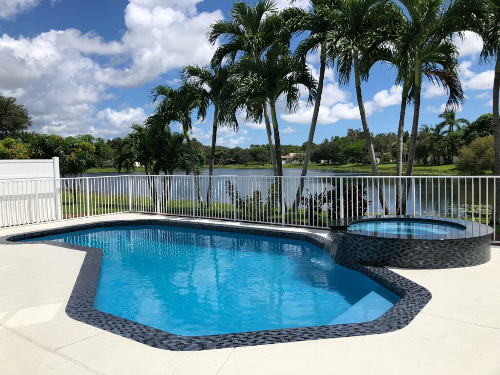 An inground swimming pool with a hot tub