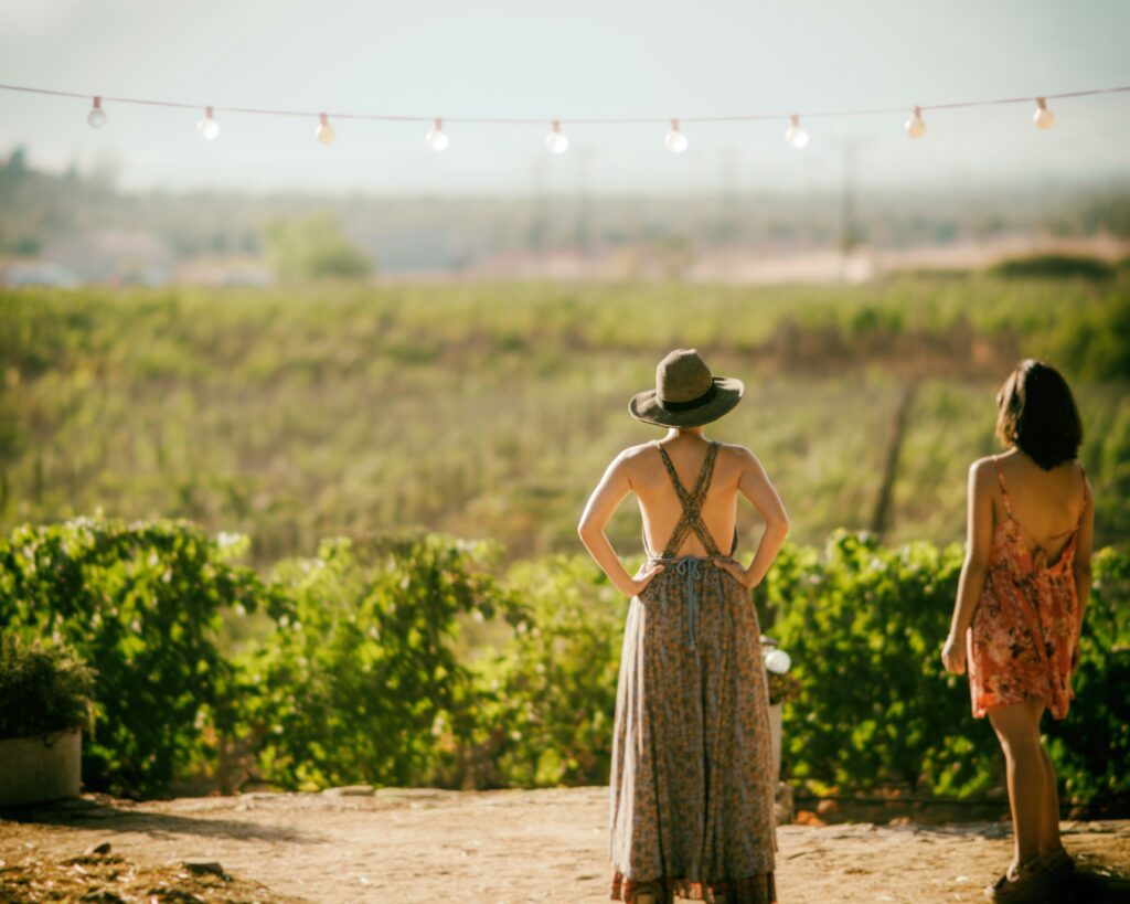 A boho look with a green, flowy maxi dress and green hat to match.