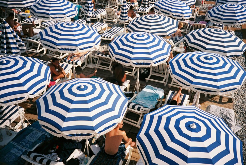 Blue and white umbrellas on a beach in Nice, France