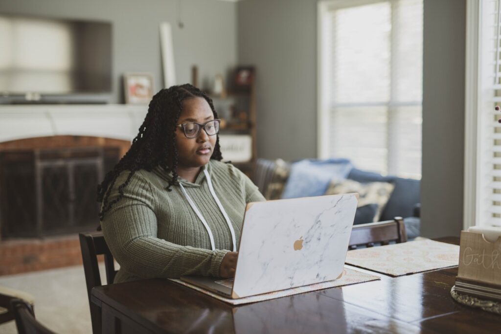 A woman working on her laptop at home