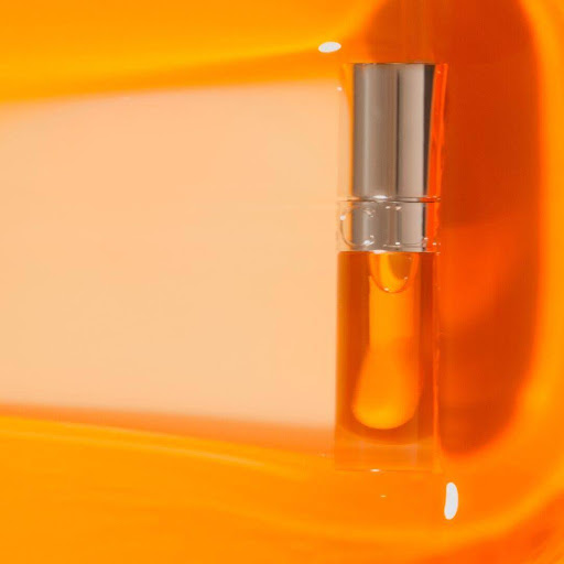 A tube of an orange lip oil