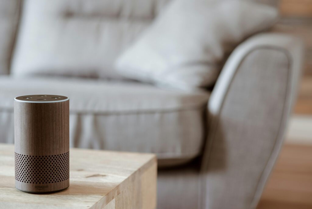 A brown Amazon Echo with Alexa on a coffee table