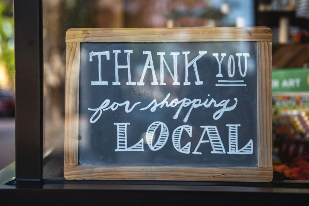 A small chalkboard sign that states thank you for shopping local