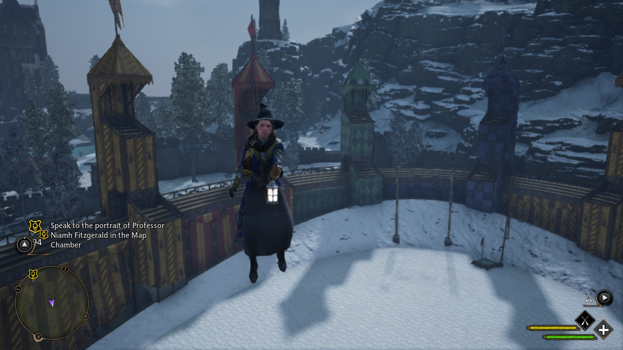 A screenshot from Hogwarts Legacy of my character flying on a broom in the Quidditch Field at Hogwarts