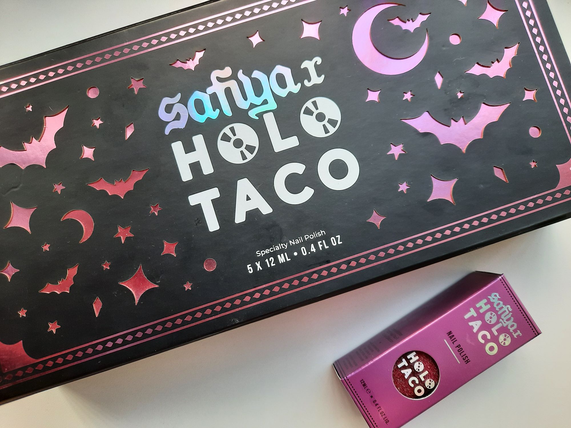 The Safiya x Holo Taco nail polish collection box. Painting nails is a cozy hobby you can have to promote self-care