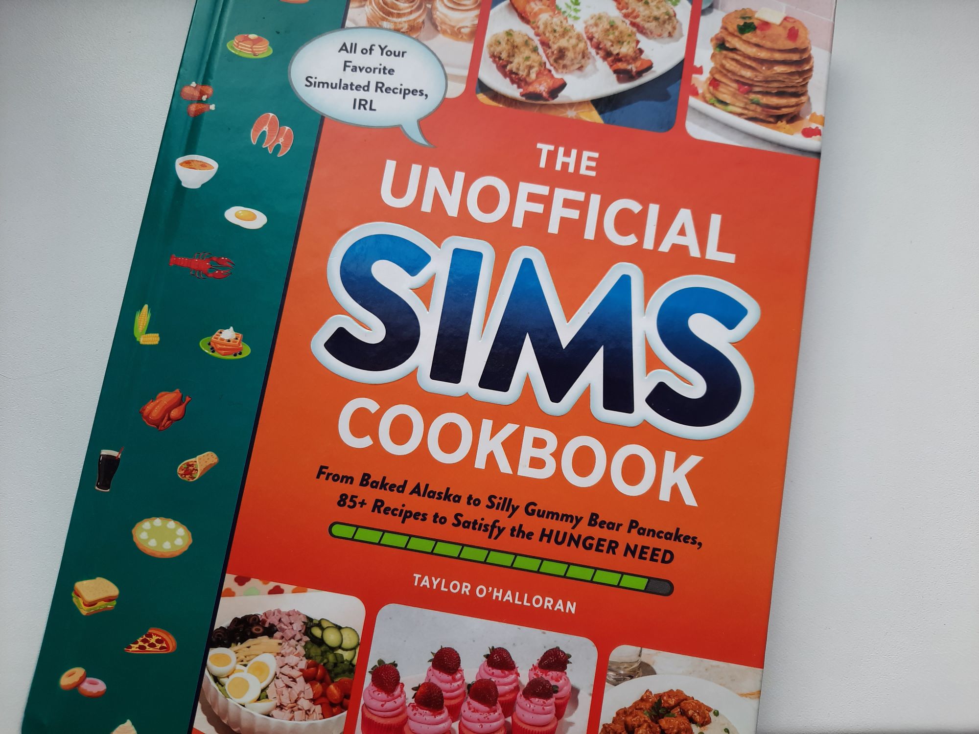The cover of The Unofficial Sims Cookbook by Taylor O'Halloran which shows 6 of the recipes in the book. Cooking is another cozy hobby for me.