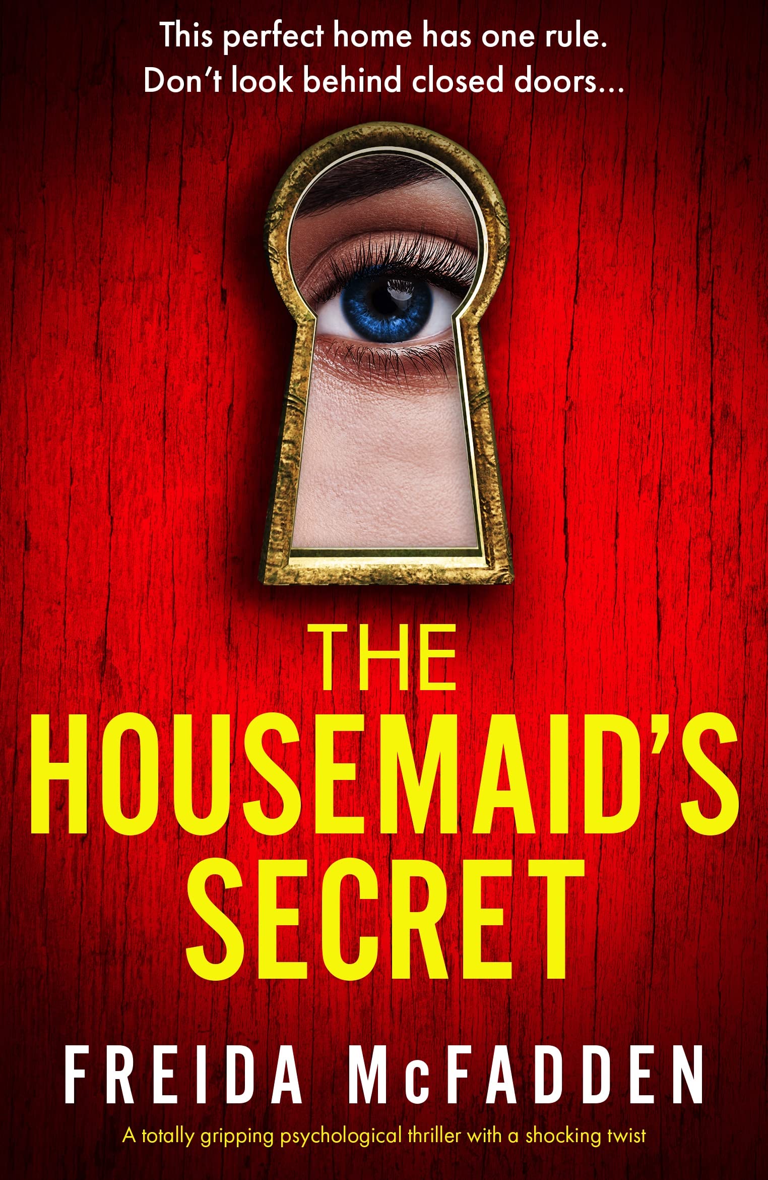 The cover of The Housemaid's Secret which has a red background and shows a closeup of an eye looking through a keyhole.