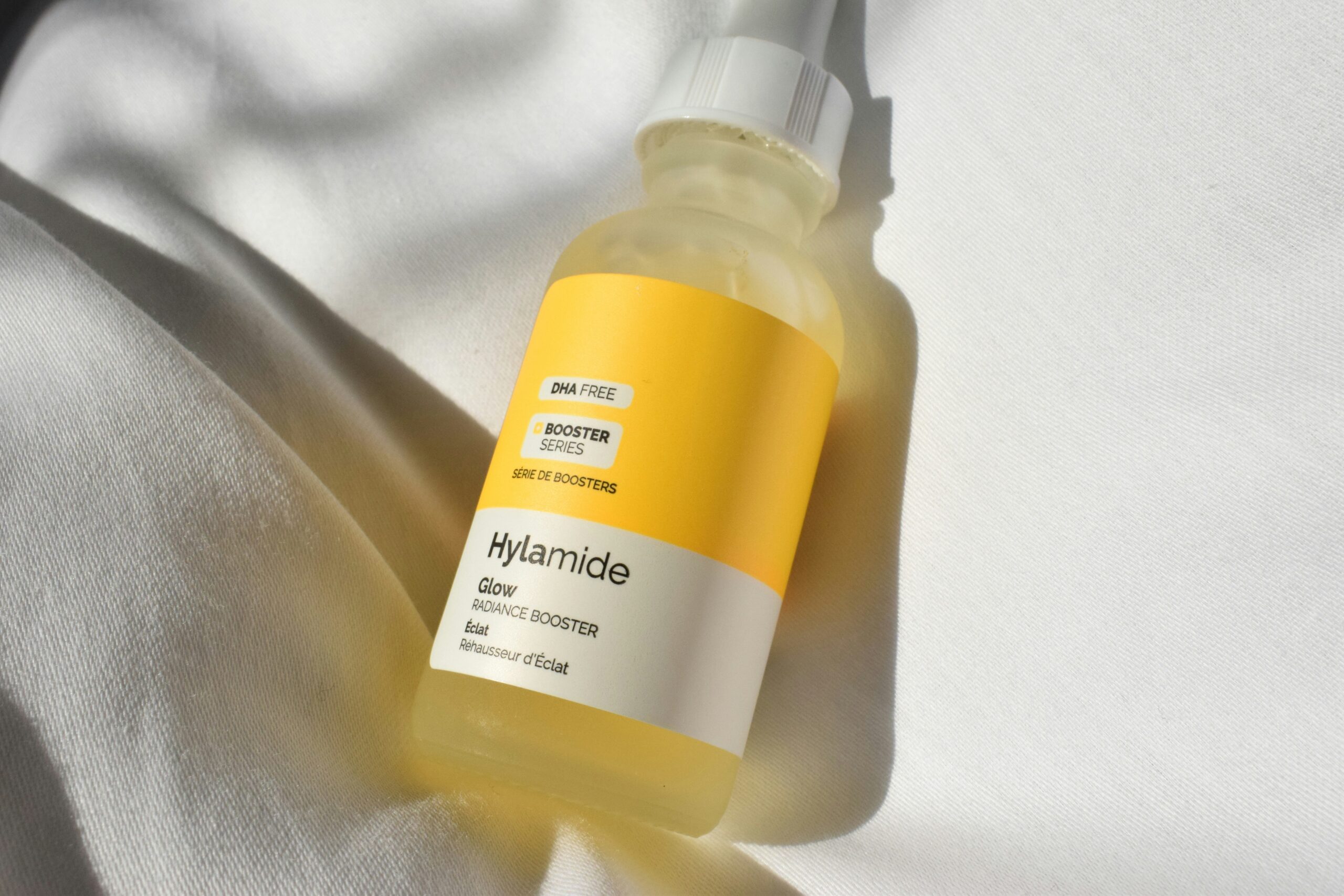 A closeup of a Hylamide glow radiance booster on a plain white background