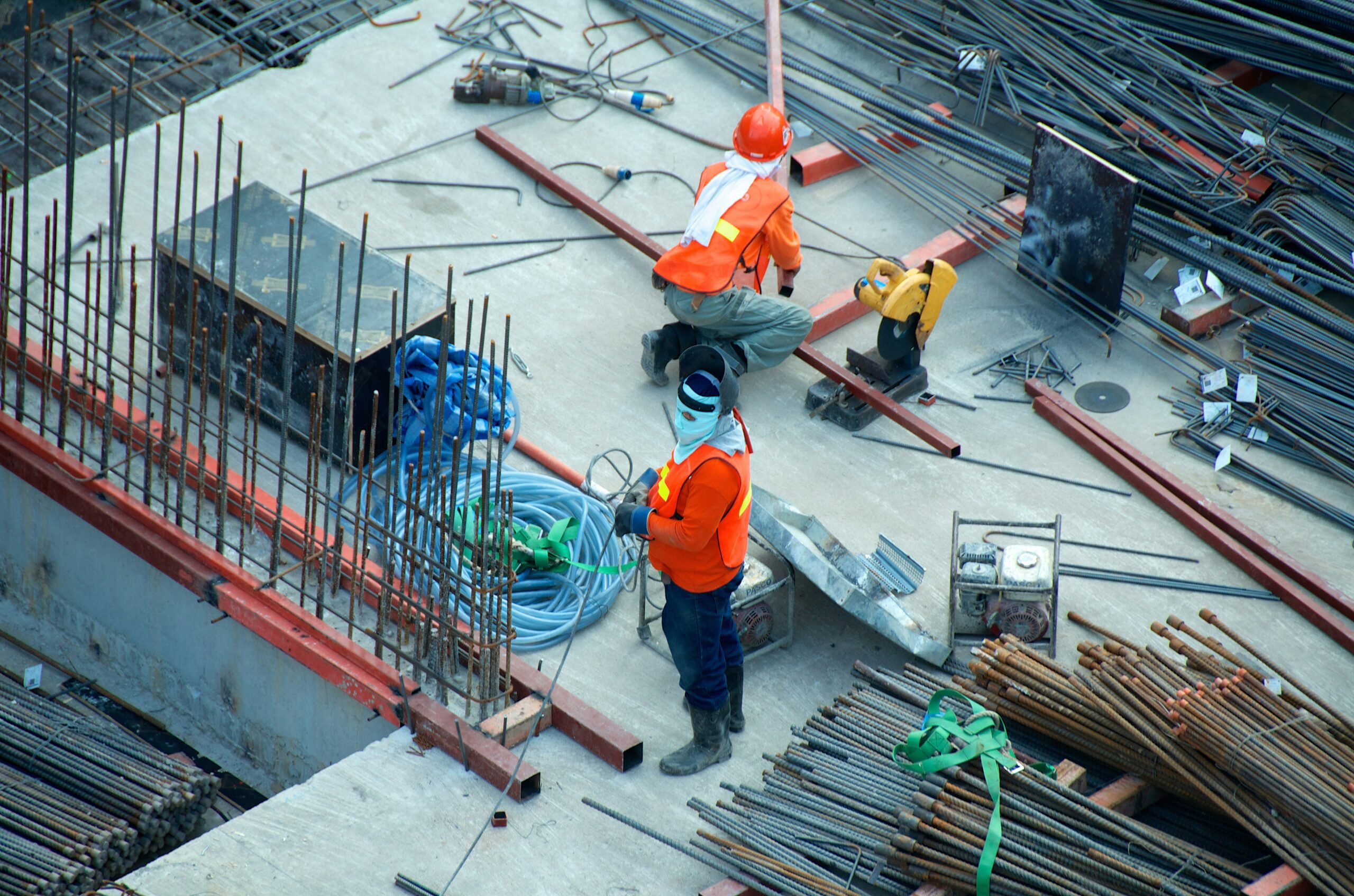 Two construction men working on a building