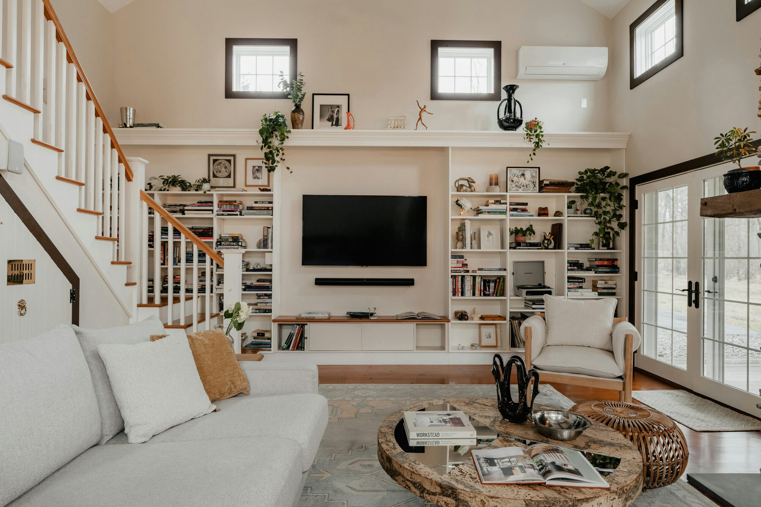 A living room in a home with a rug under the the couch and coffee table