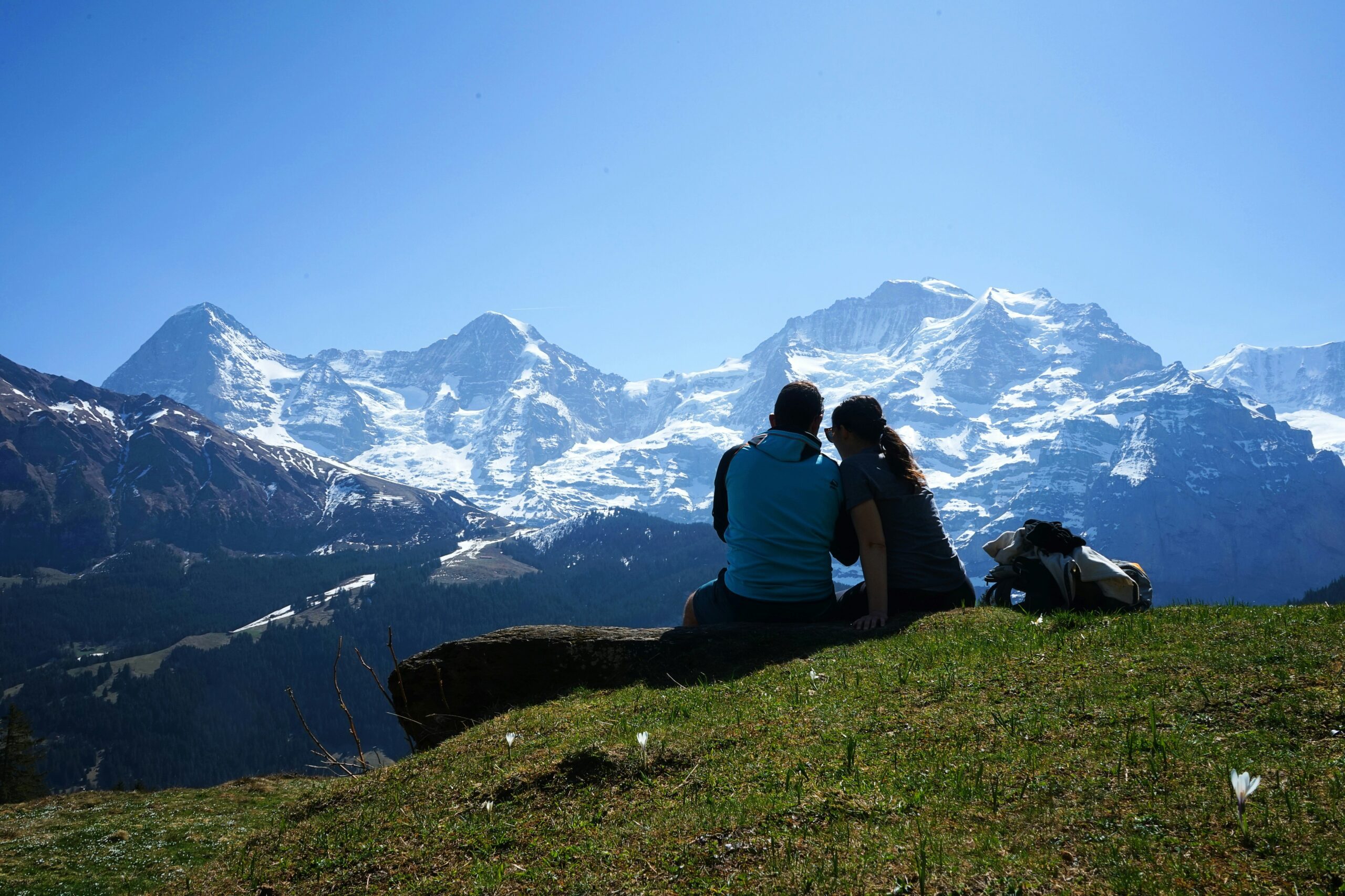 A couple sitting and enjoying the view of the mountains in Lauterbrunnen, Switzerland