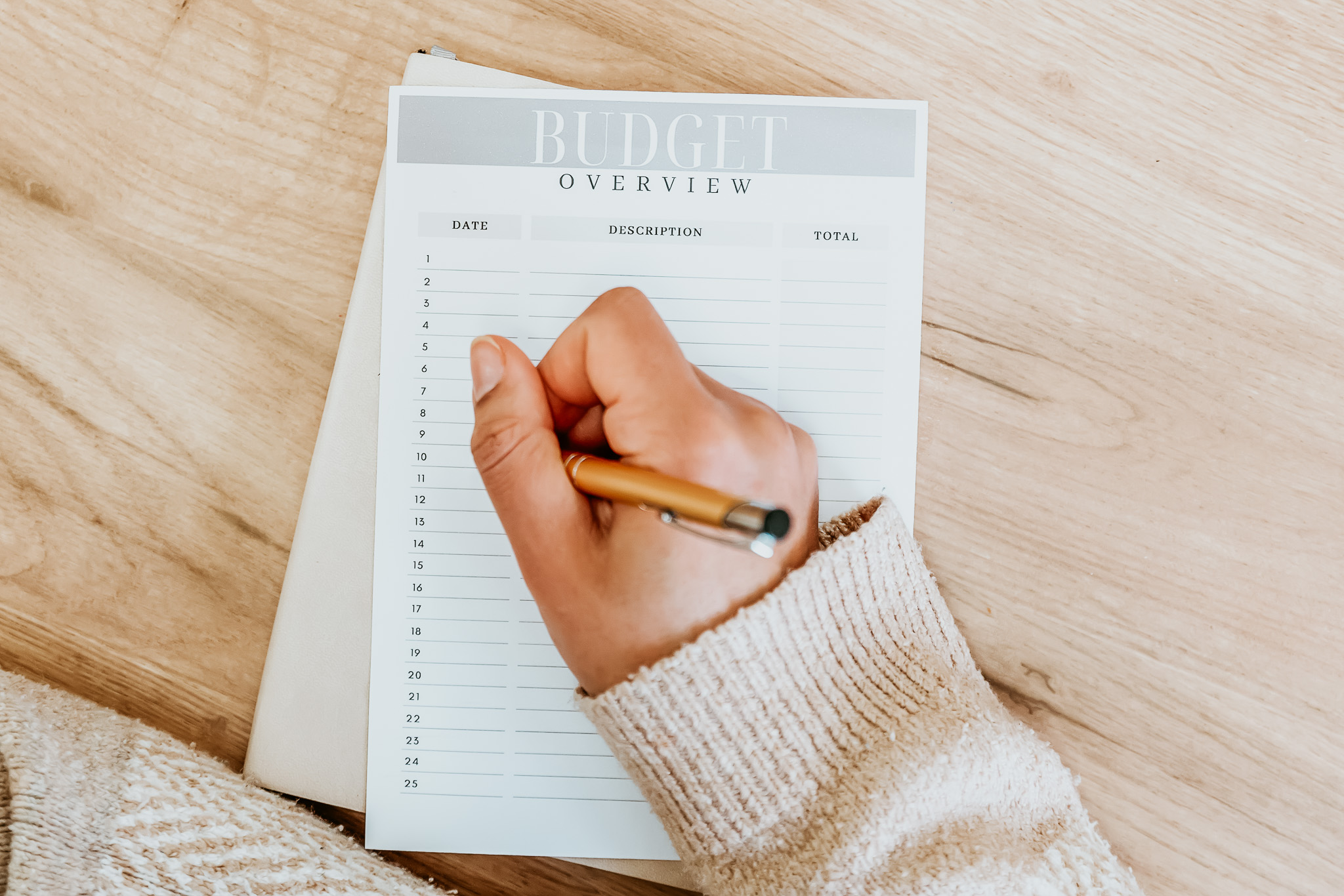 A close up of a woman writing a budget plan