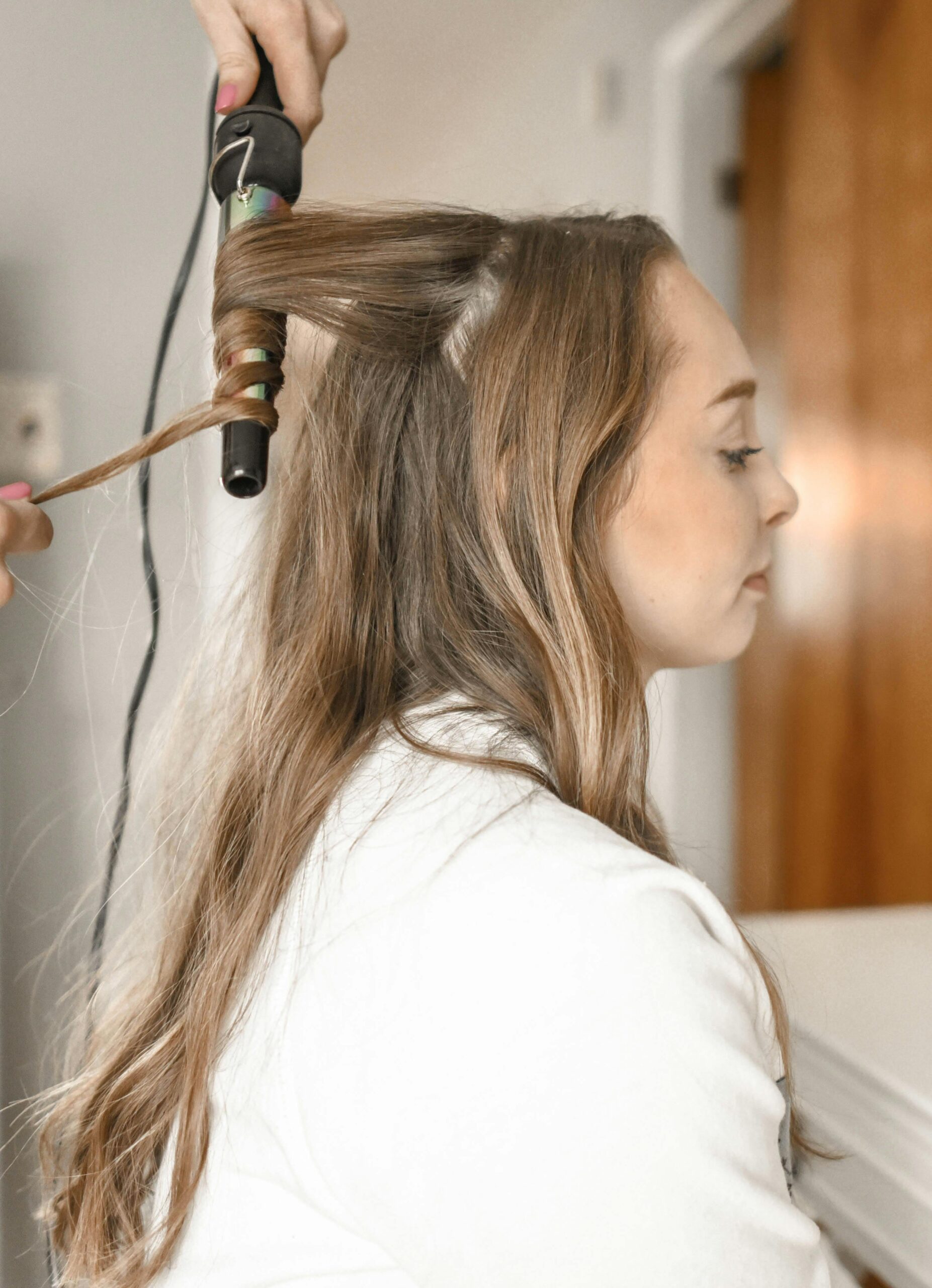 A woman having her hair curled