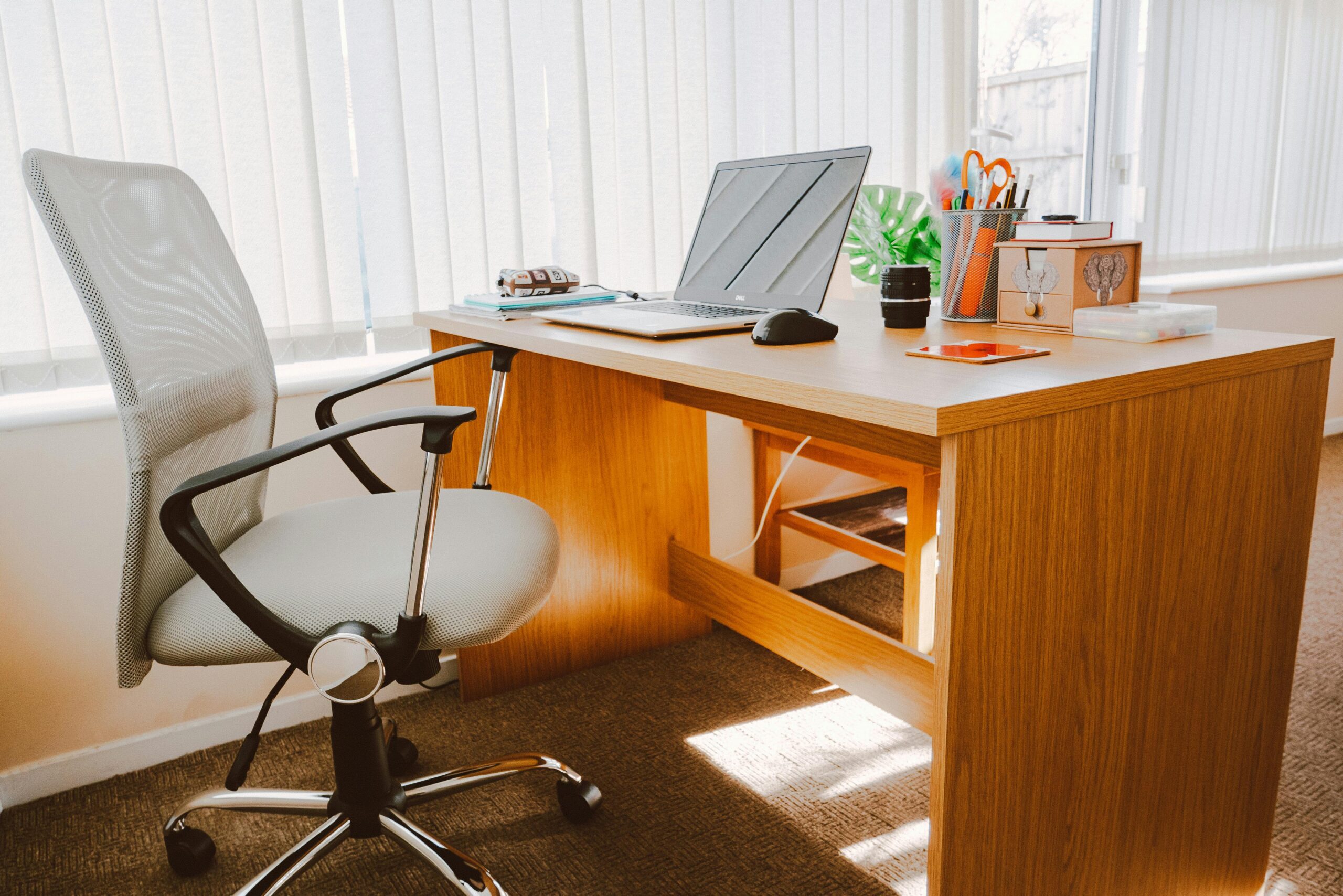 A tidy and organized desk with a laptop