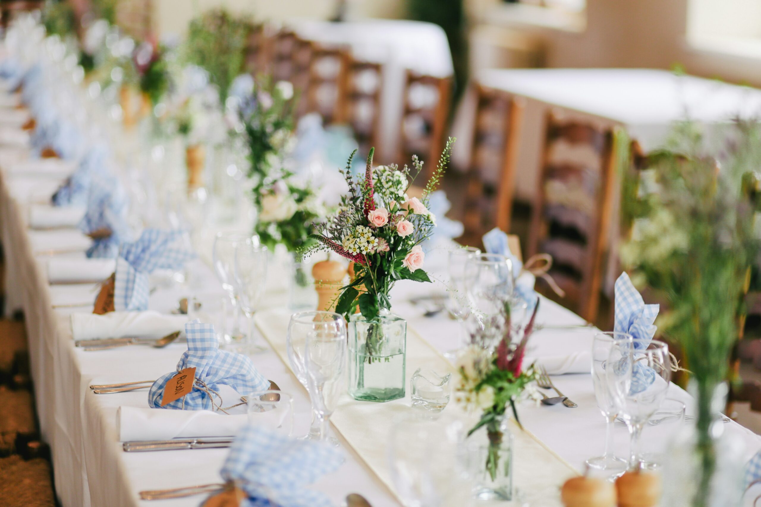 A wedding diner table with floral centerpieces