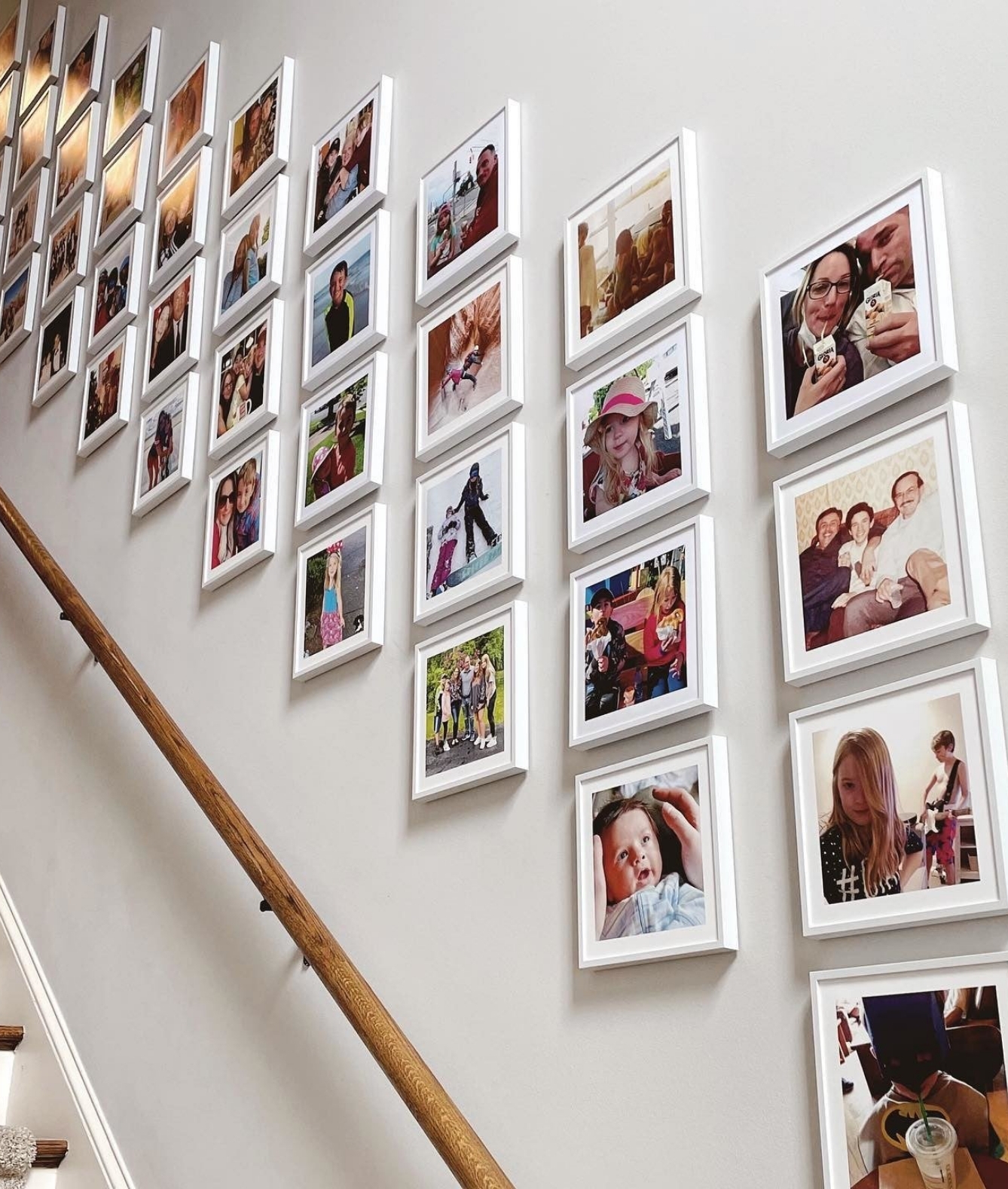 A gallery wall of photos along a staircase